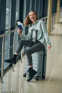 Traveler holding passport and approved travel documents from Travel Smart Travel Fast